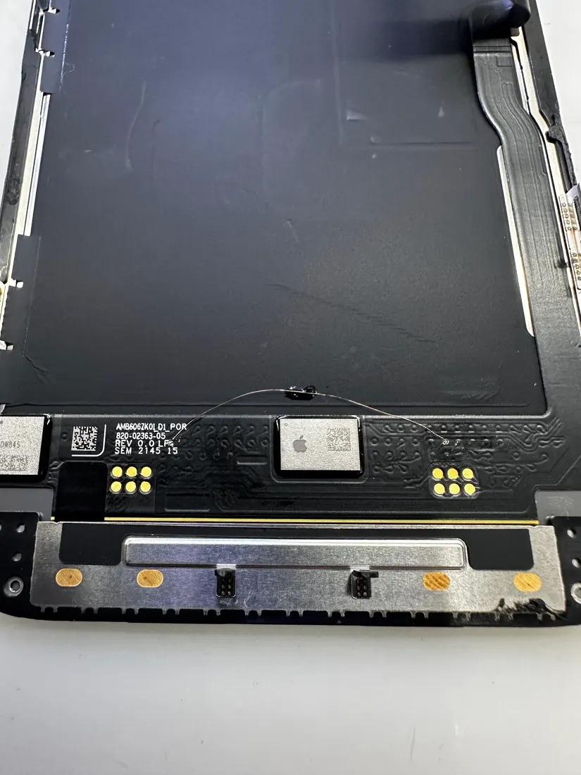 iPhone 13 Pro 螢幕模組背面特寫,可見排線接點與金屬遮蔽